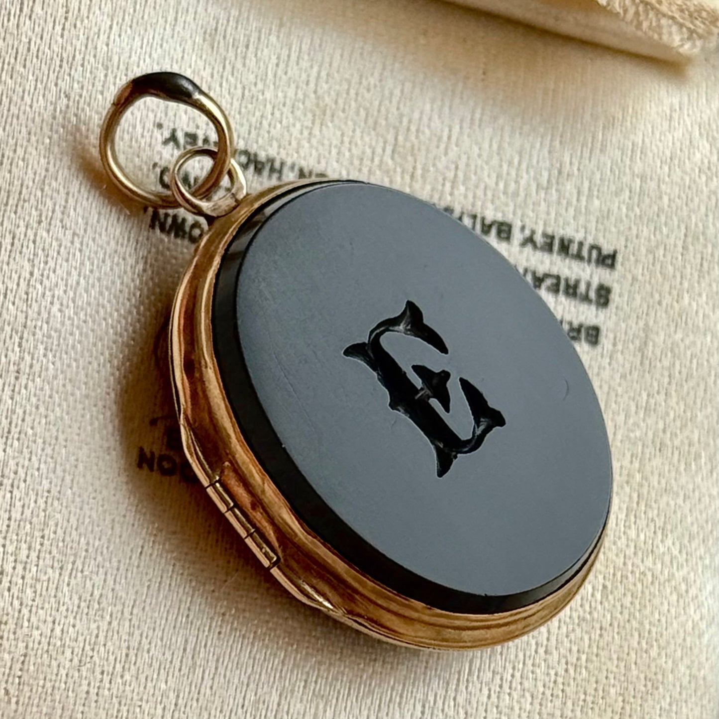 Antique 'E' Onyx Oval Locket in 9 Carat Gold; Circa 1895