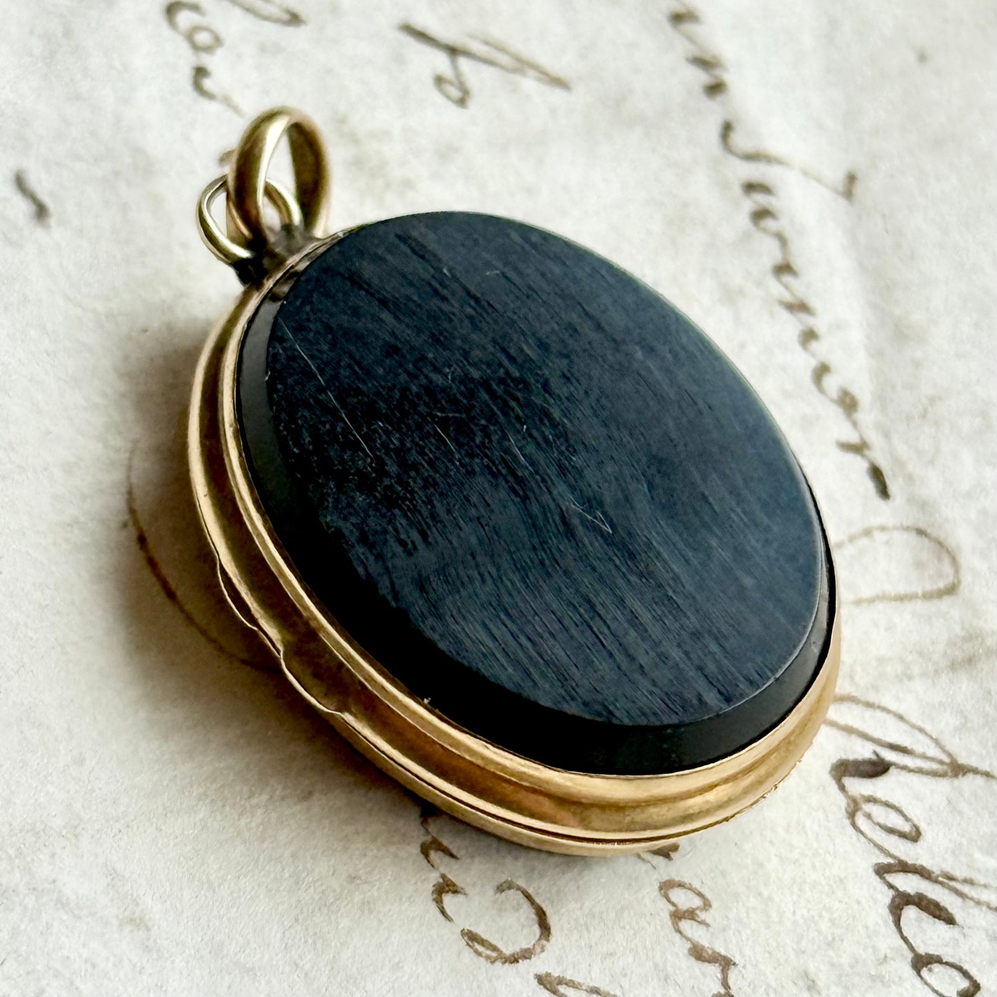 Antique 'E' Onyx Oval Locket in 9 Carat Gold; Circa 1895