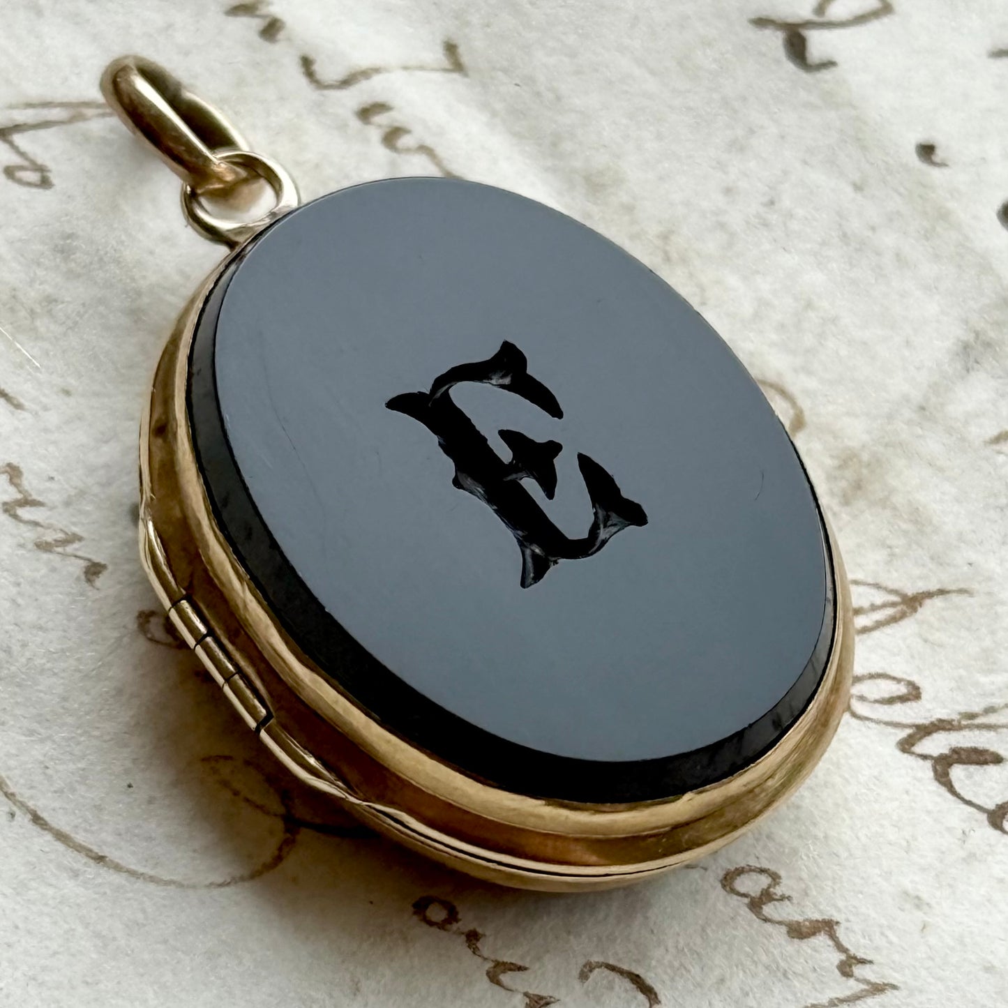 Antique 'E' Onyx Oval Locket in 9 Carat Gold; Circa 1895