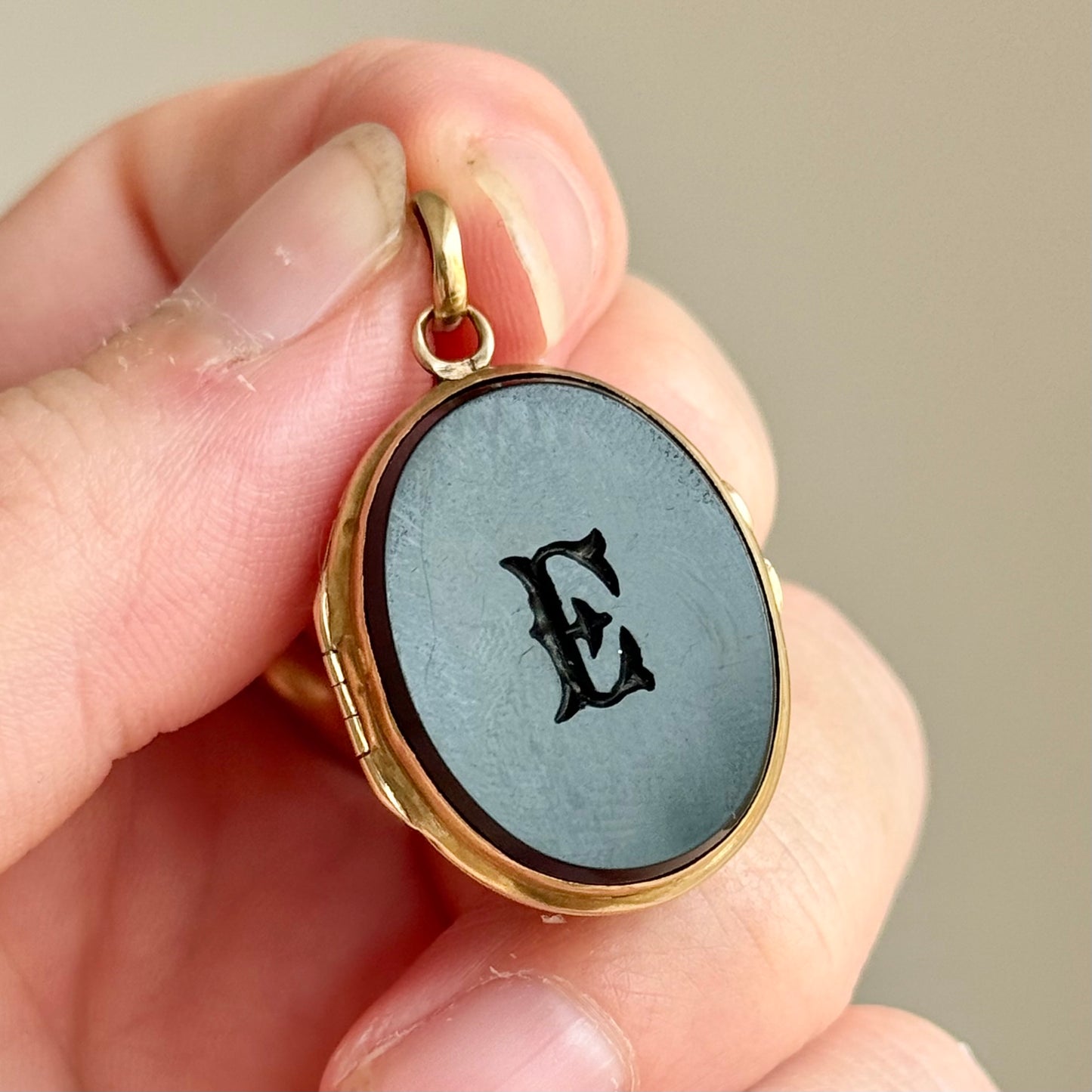 Antique 'E' Onyx Oval Locket in 9 Carat Gold; Circa 1895
