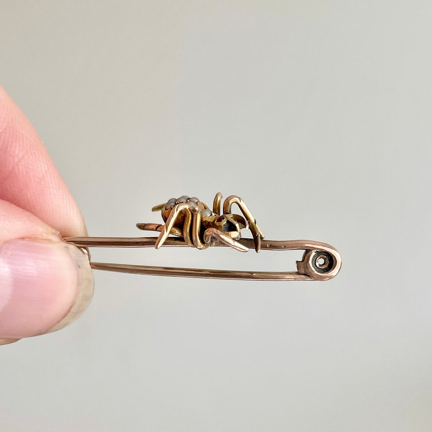 Victorian Spider Ruby and Pearl Brooch in 9 Carat Rose Gold; Circa 1890